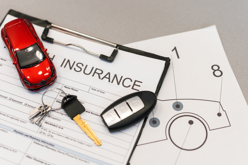Car Insurance paperwork and model car