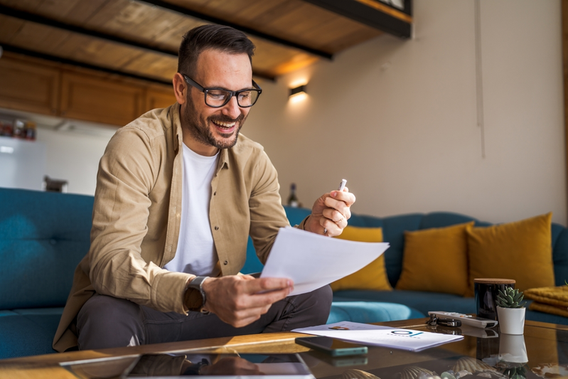 happy man holding insurance document